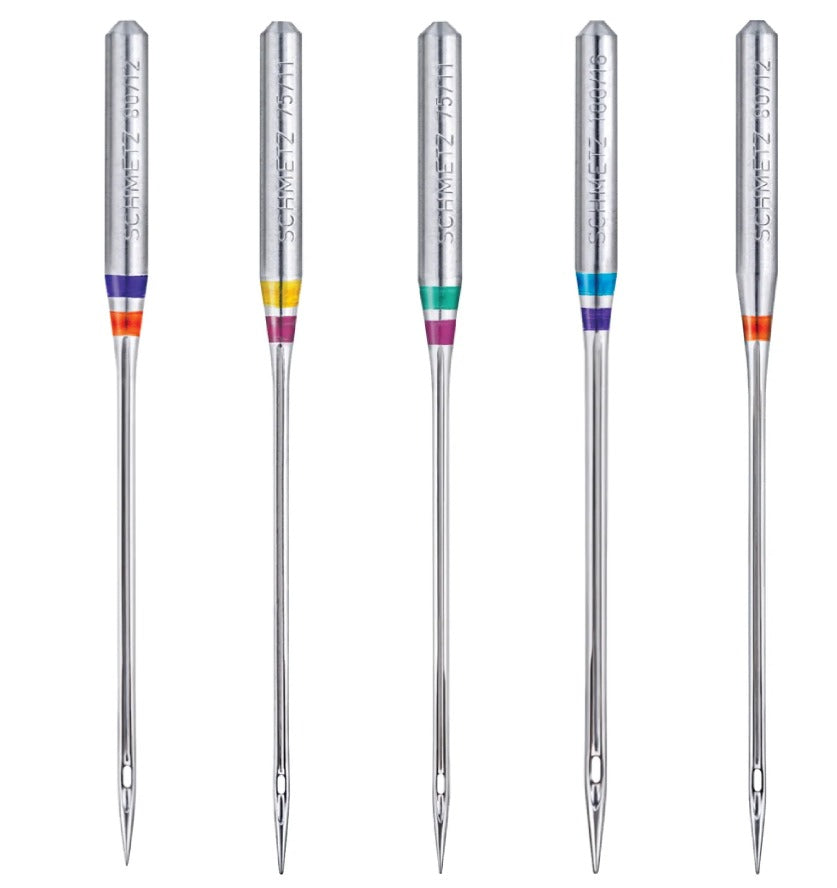 schmetz domestic needles five domestic schmetz brand needles in a line, showing colour coding markings.