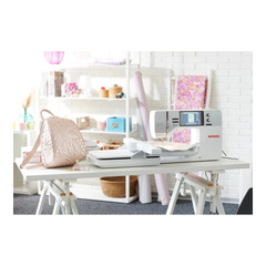 Sewing machine on a table with a white background