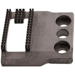 A black feed dog component for a Bernina sewing machine.