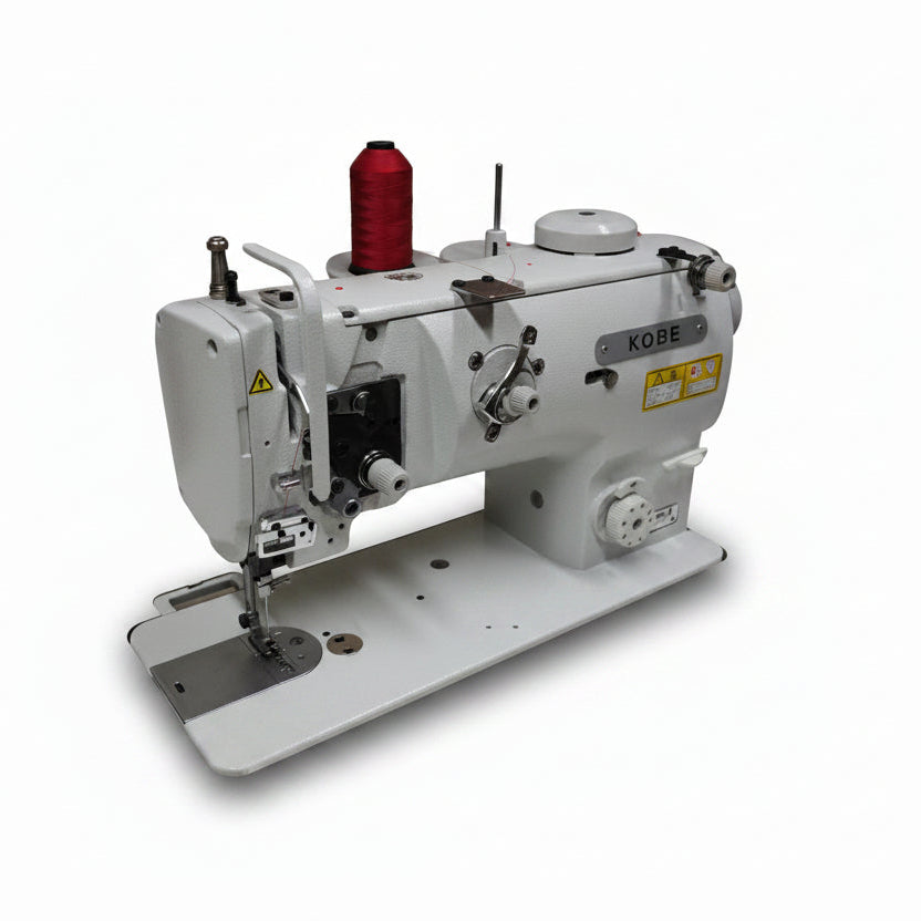 A white industrial sewing machine with a red spool of thread on top, photographed against a plain light gray background.