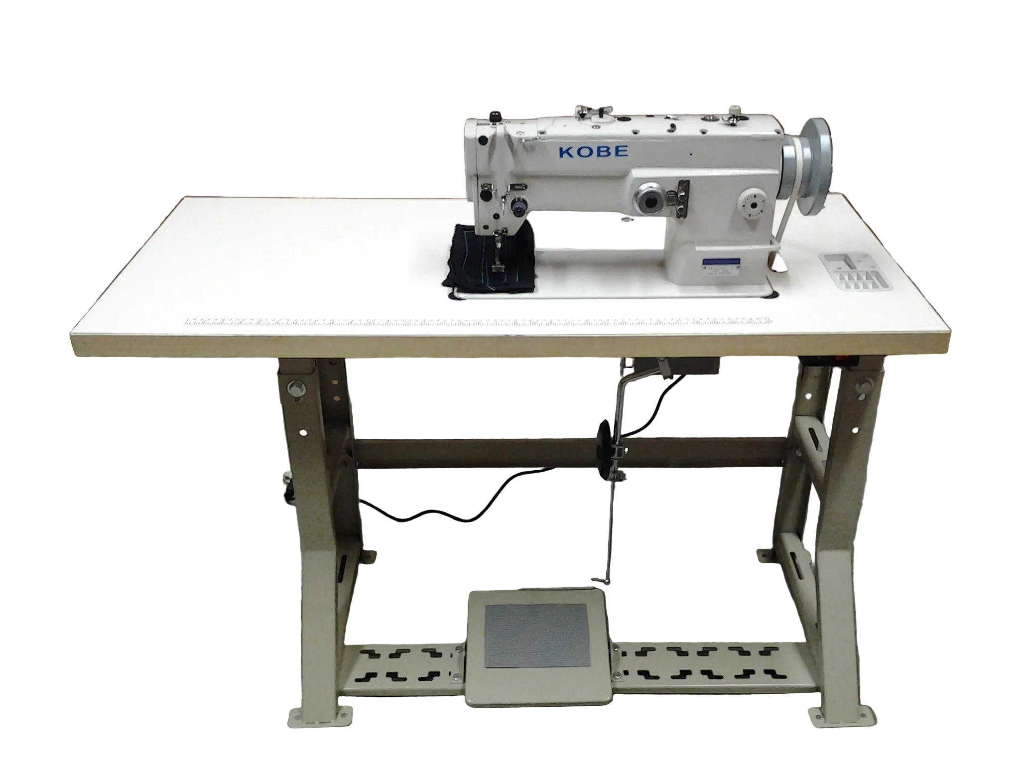 Kobe sewing machine on a white table with cardboard boxes in the background