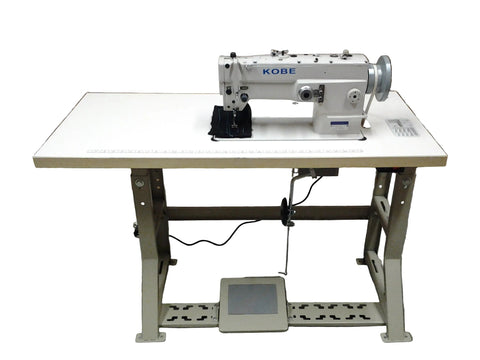 Kobe sewing machine on a white table with cardboard boxes in the background