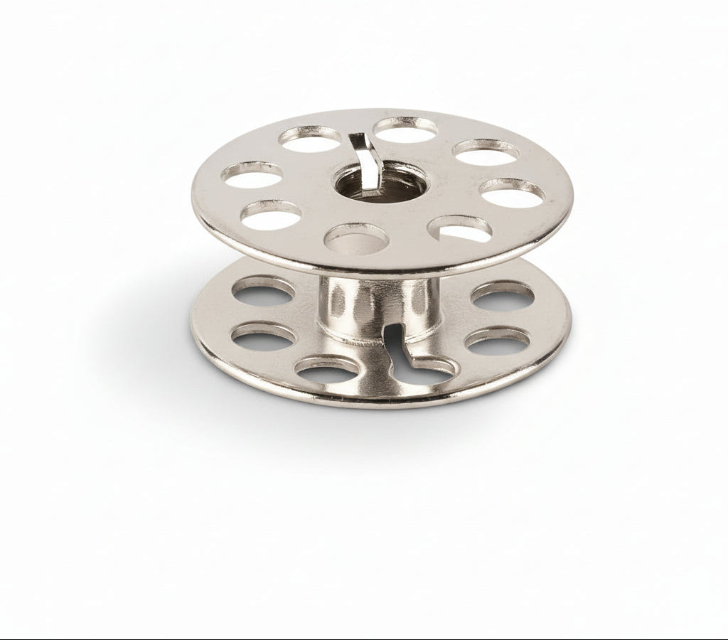 Two metal spools on a white background