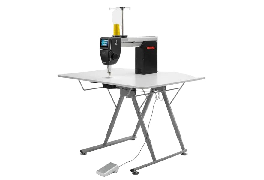 Sewing machine on a white table with a white background